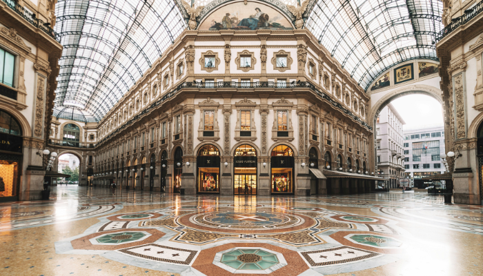 Interior of the Galleria Vittorio Emanuele II, a historic shopping arcade and major stop on Milan sightseeing bus routes.