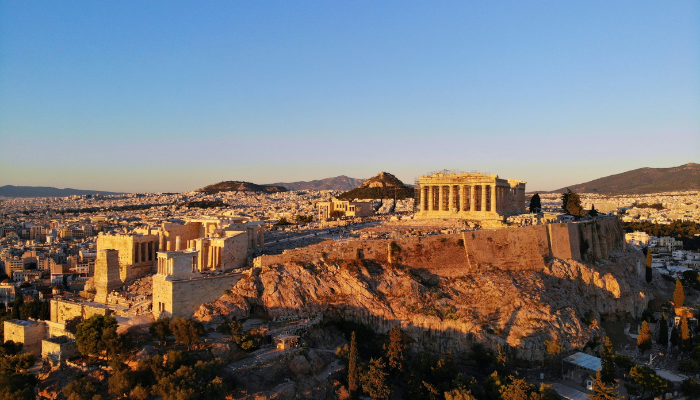 Panoramic view of the Acropolis and Athens cityscape at golden hour.