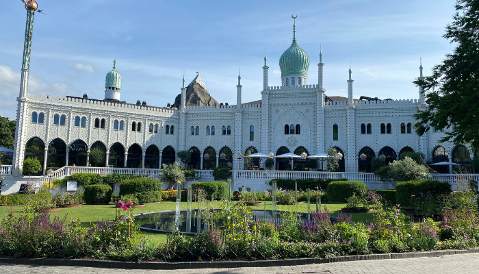 Tivoli Gardens in Copenhagen with its ornate Moorish-style entrance building, green domes and landscaped gardens.