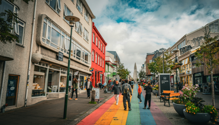 Rainbow-painted Skólavörðustígur street lined with shops and colourful buildings in Reykjavik