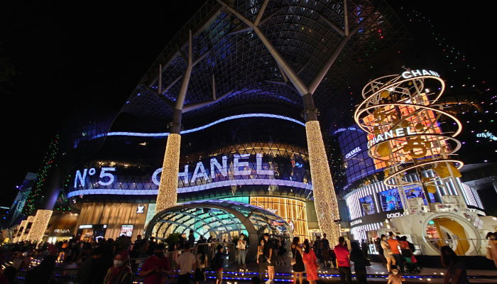 Busy Orchard Road shopping area illuminated at night in Singapore.