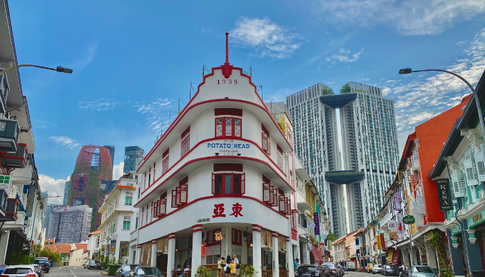 Colourful shophouses and historic architecture along a street in Singapore.