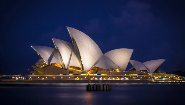 Sydney Opera House illuminated at night, one of the most popular attractions on the Sydney hop-on hop-off bus route.