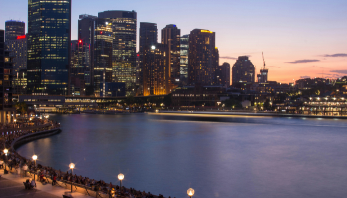 Evening view of Circular Quay and Sydney's waterfront skyline, a major stop on the Sydney hop-on hop-off bus route.