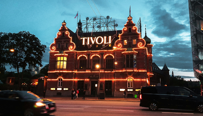 Tivoli Gardens entrance in Copenhagen illuminated with warm lights on an autumn evening