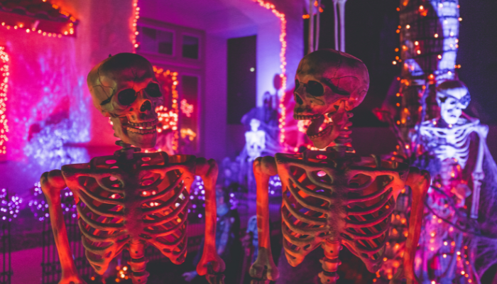 Halloween decorations featuring illuminated skeletons, pumpkins and colourful lights indoors