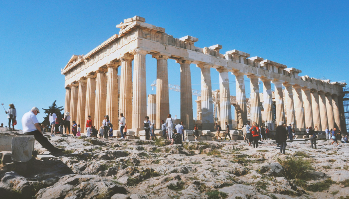 The Parthenon on the Acropolis in Athens with visitors exploring the ancient site