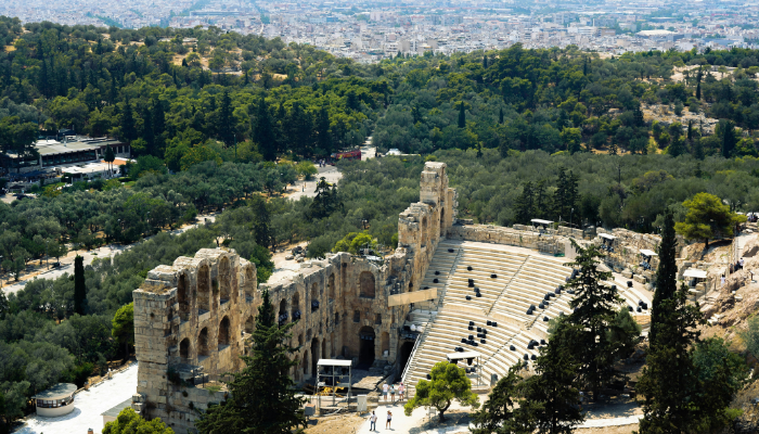 Ancient Theatre of Dionysus below the Acropolis surrounded by greenery in Athens