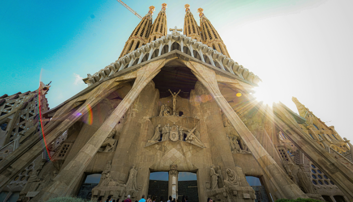 Sagrada Família in Barcelona with sunlight shining through its ornate façade