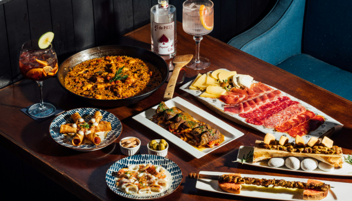 Traditional Spanish dishes including paella, tapas and cured meats served at a Barcelona restaurant