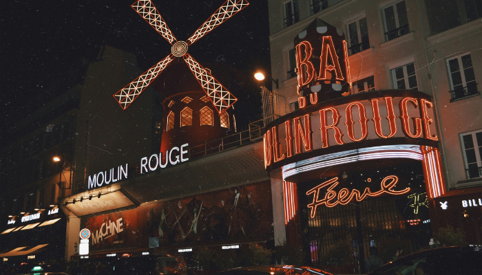 Moulin Rouge cabaret in Paris illuminated by red neon lights at night