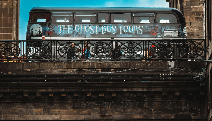 Ghost Bus Tours vehicle crossing a historic Edinburgh bridge