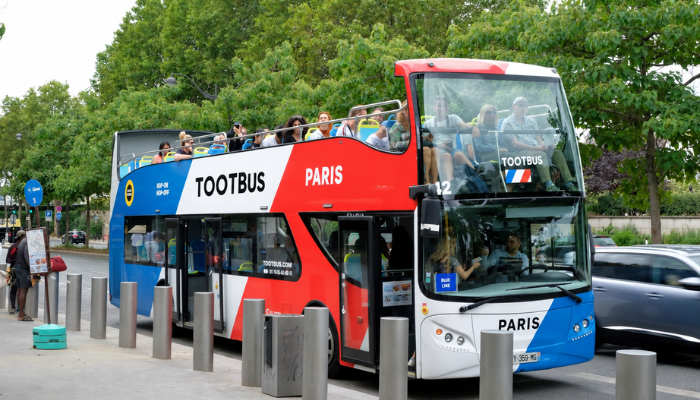 Tootbus Paris open-top sightseeing bus with passengers on board