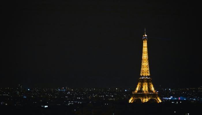 Eiffel Tower illuminated at night against the Paris skyline